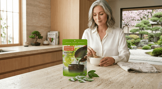 A woman prepares a bowl of matcha tea using a Superfood Science ceremonial grade certified organic Matcha tea packet by Superfood Science..