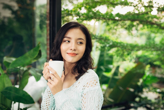 superfood science matcha green tea woman enjoying to go packet outside green scenery 